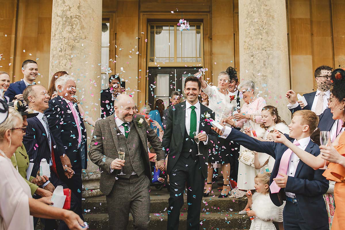 Grooms confetti exit - gay wedding photography