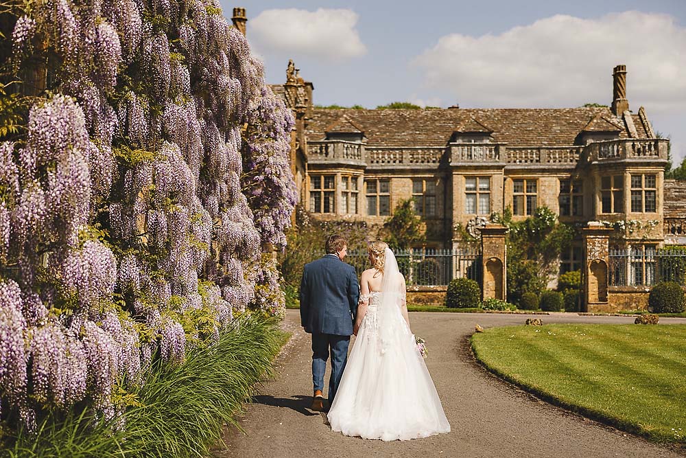 Bride and groom walking through the gardens at Mapperton Gardens in Dorset