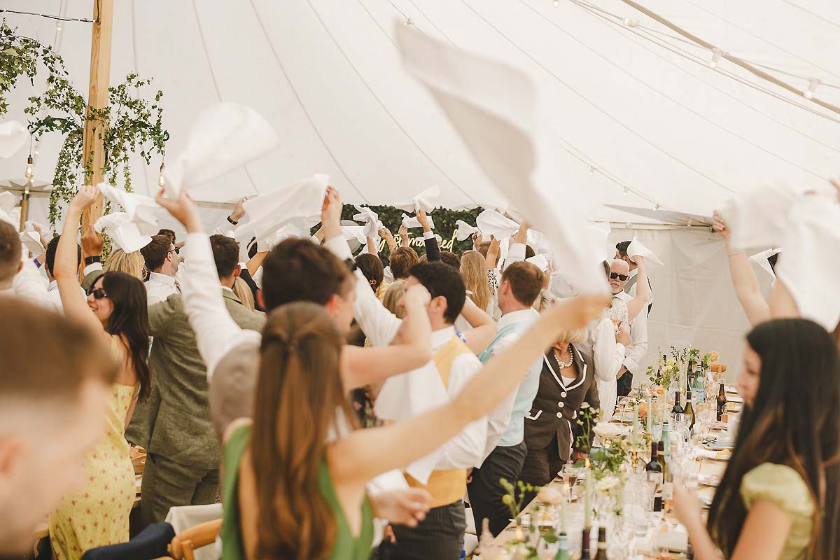 Creative wedding photography capturing the joyful welcome into the reception