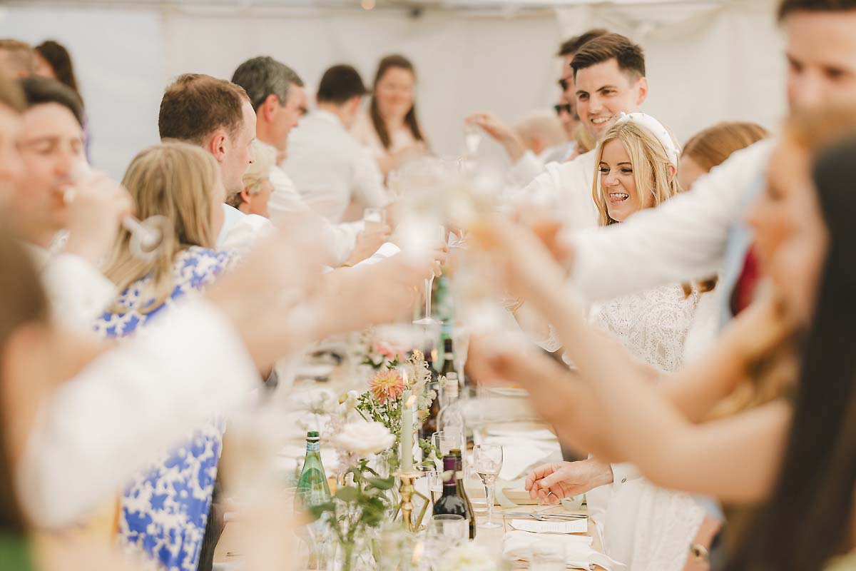 Heartfelt wedding speeches during dinner inside the marquee