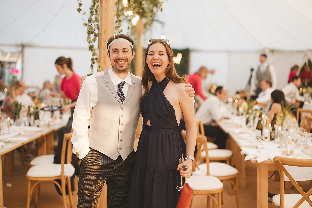 Candid guest moments during golden hour at a summer wedding