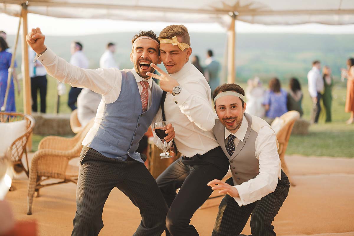 Candid guest moments during golden hour at a summer wedding