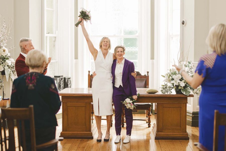Brides cheer during Register office wedding Bournemouth Town Hall