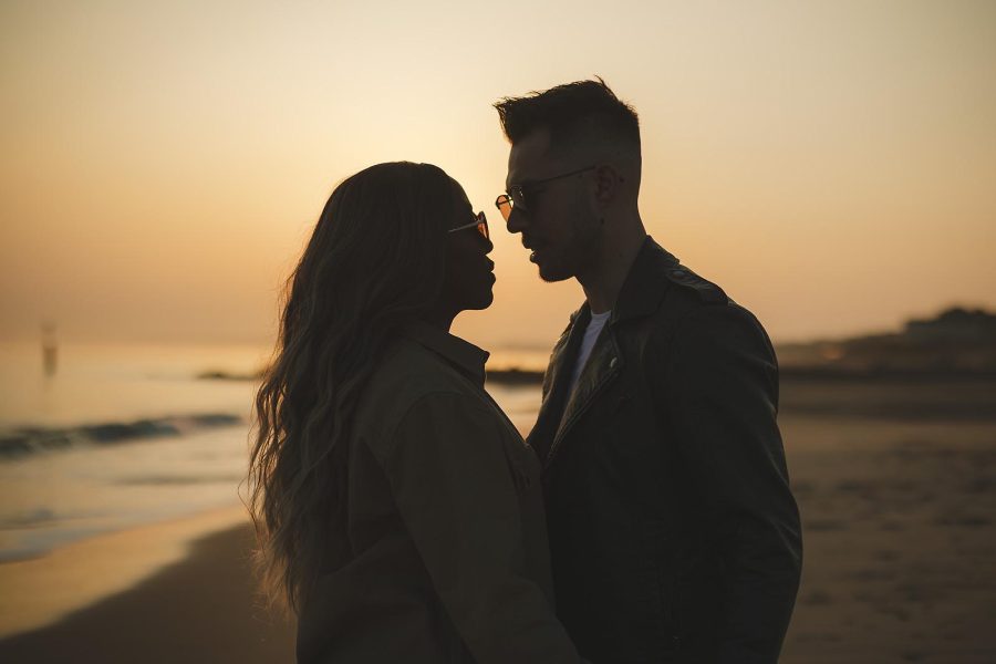 Close up of couple at sunset with view over to Bournemouth beach