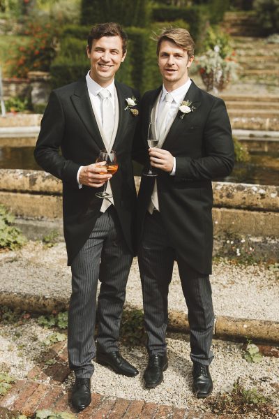 Relaxed portrait of grooms in the walled garden at Mapperton House
