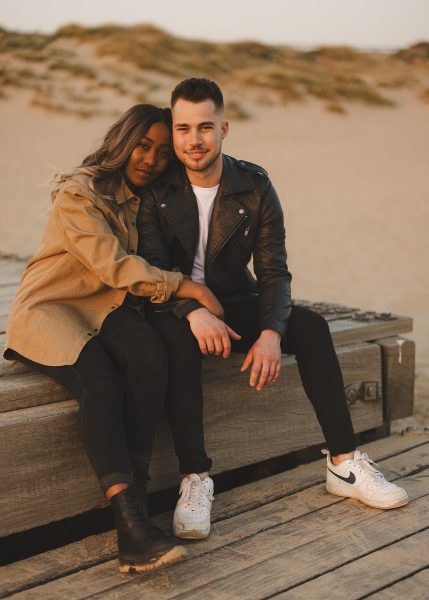 Portrait of couple sat down on the beach at Hengistbury Head