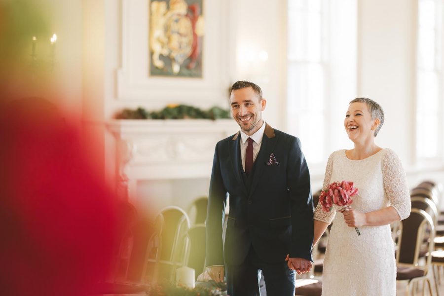 Bride and groom laughing during register office wedding in Poole