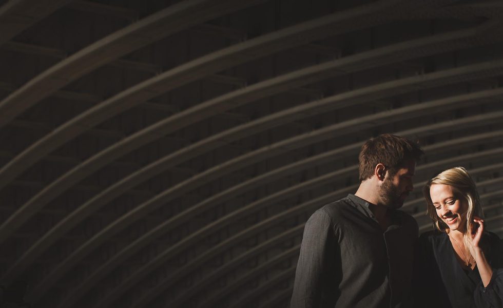 Couple walking through dramatic light and shadow during a creative lifestyle shoot