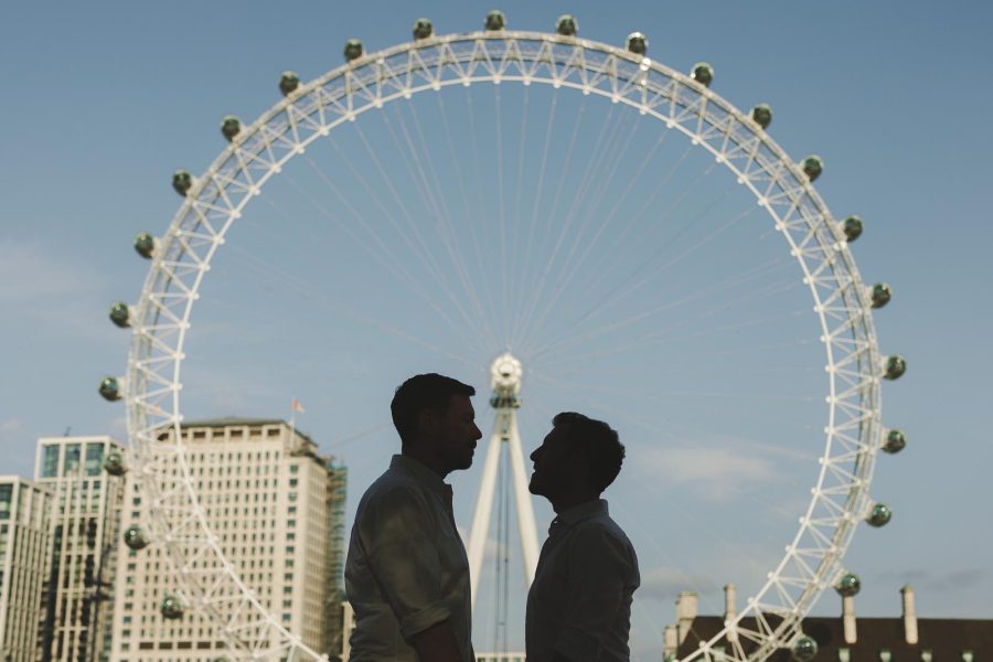 Couple silhouetted in front of city scape during a pre wedding shoot
