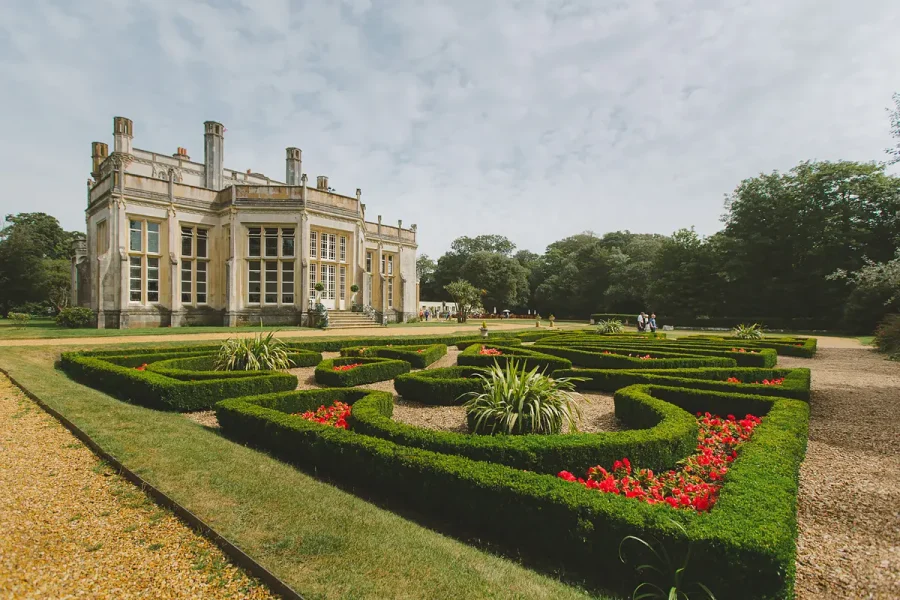 Highcliffe Castle photographed from the formal parterre garden with red and yellow tulips in full bloom