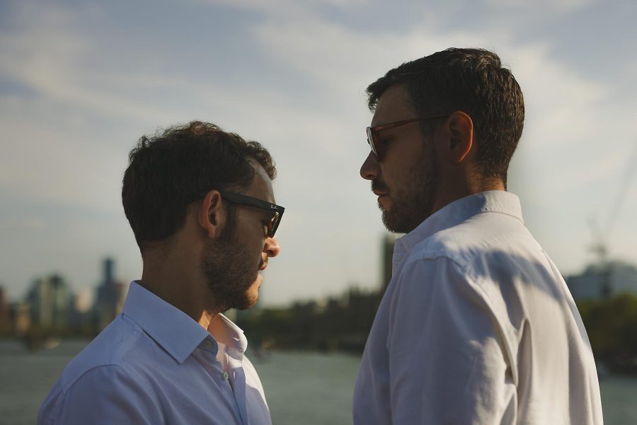 Couple facing each other during a relaxed pre wedding shoot by the river