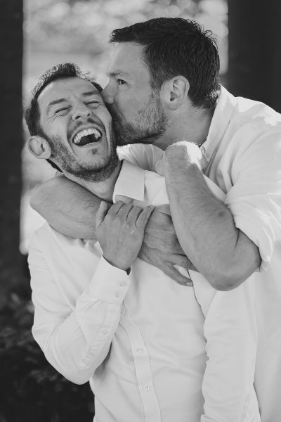 Natural black and white pre wedding shoot of a couple laughing together