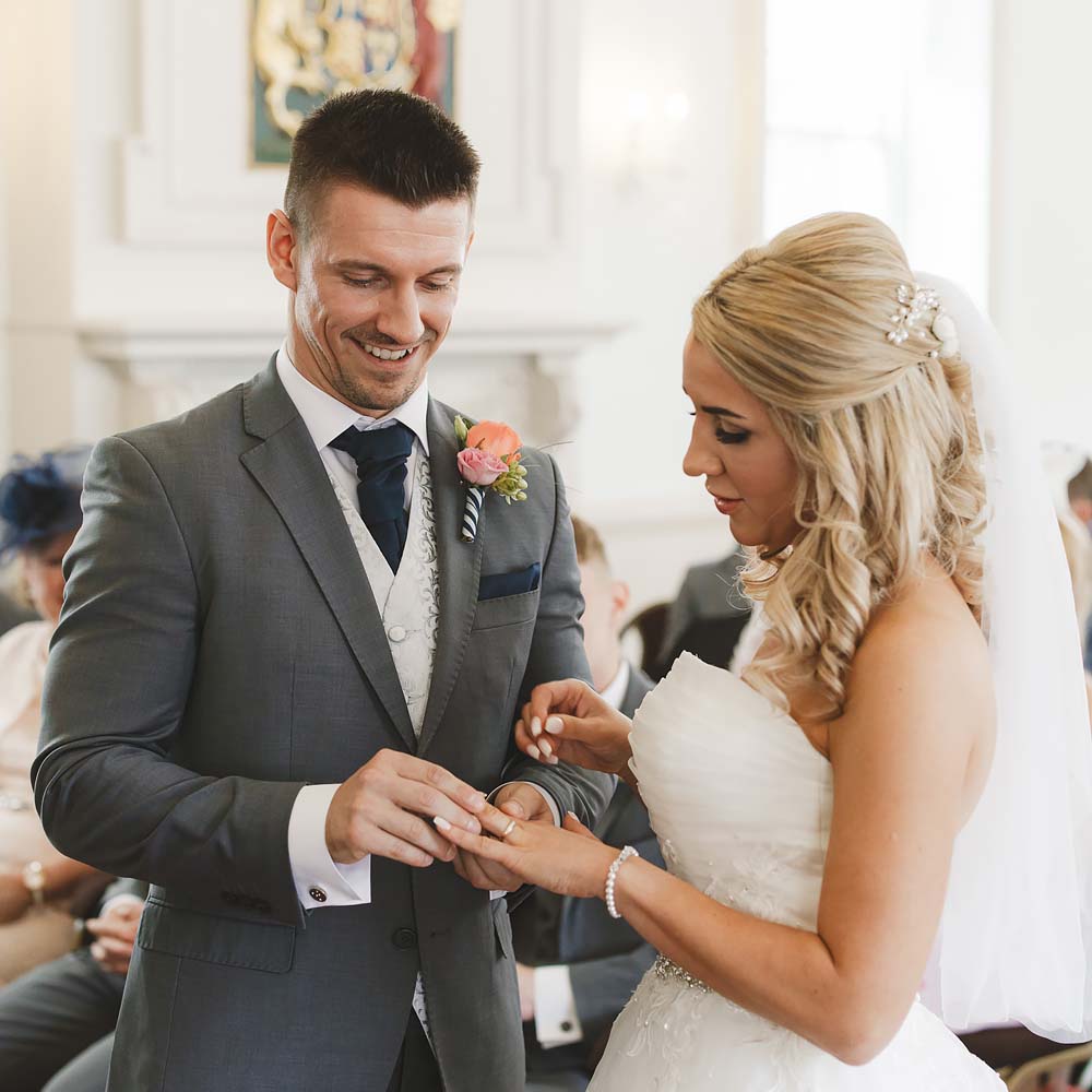 Bride and groom exchanging rings during a registry office wedding ceremony in Bournemouth and Poole