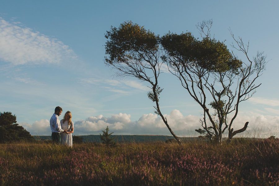 Couple standing together in heathland during a relaxed outdoor shoot