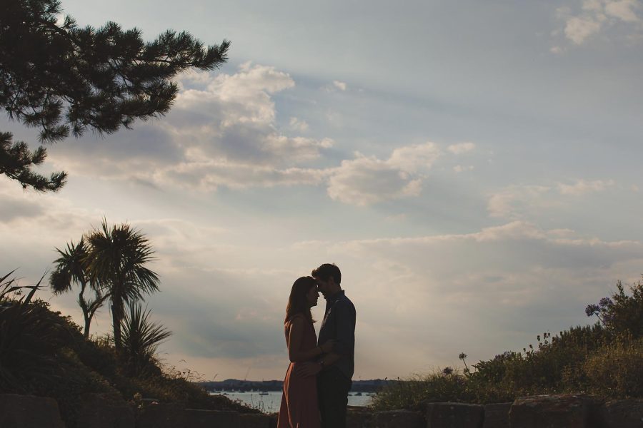 Silhouette of couple embracing at sunset during a Poole couples shoot in Dorset