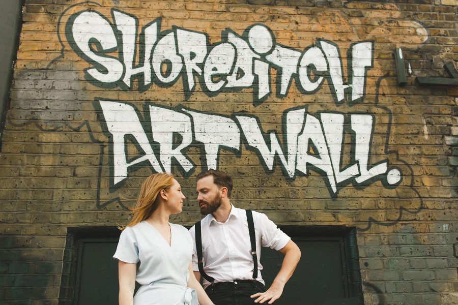 Couple during an urban pre-wedding shoot with street art backdrop
