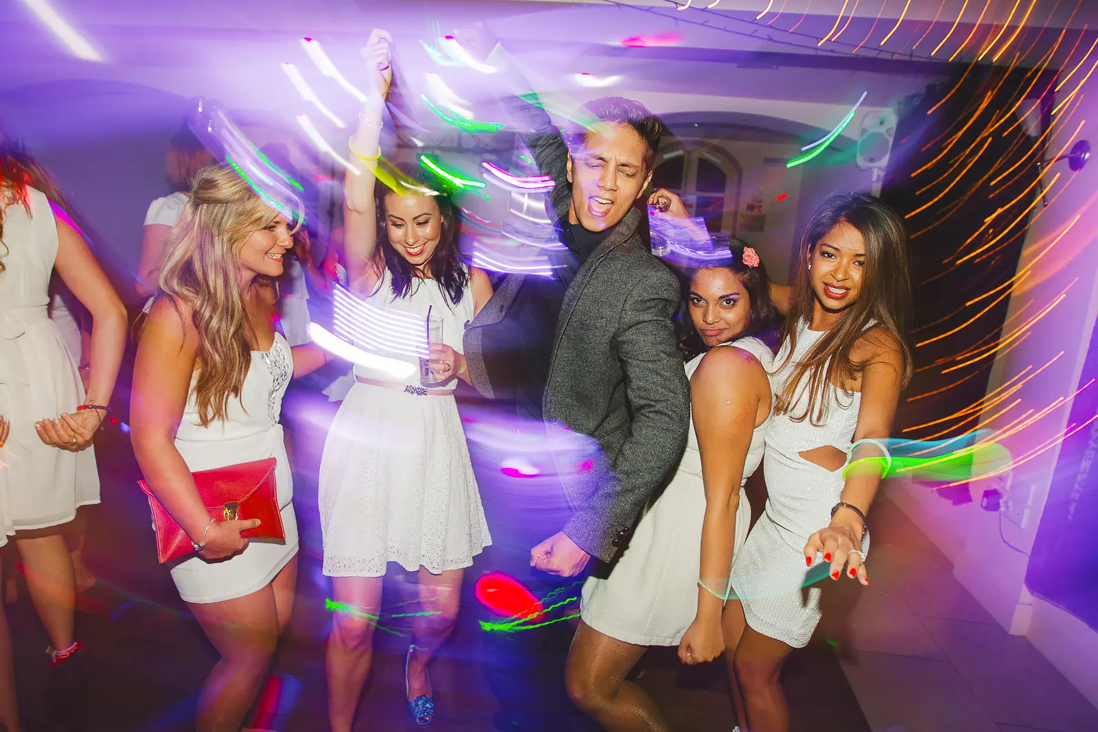 Guests dancing at an 18th birthday party in Poole with colourful party lighting