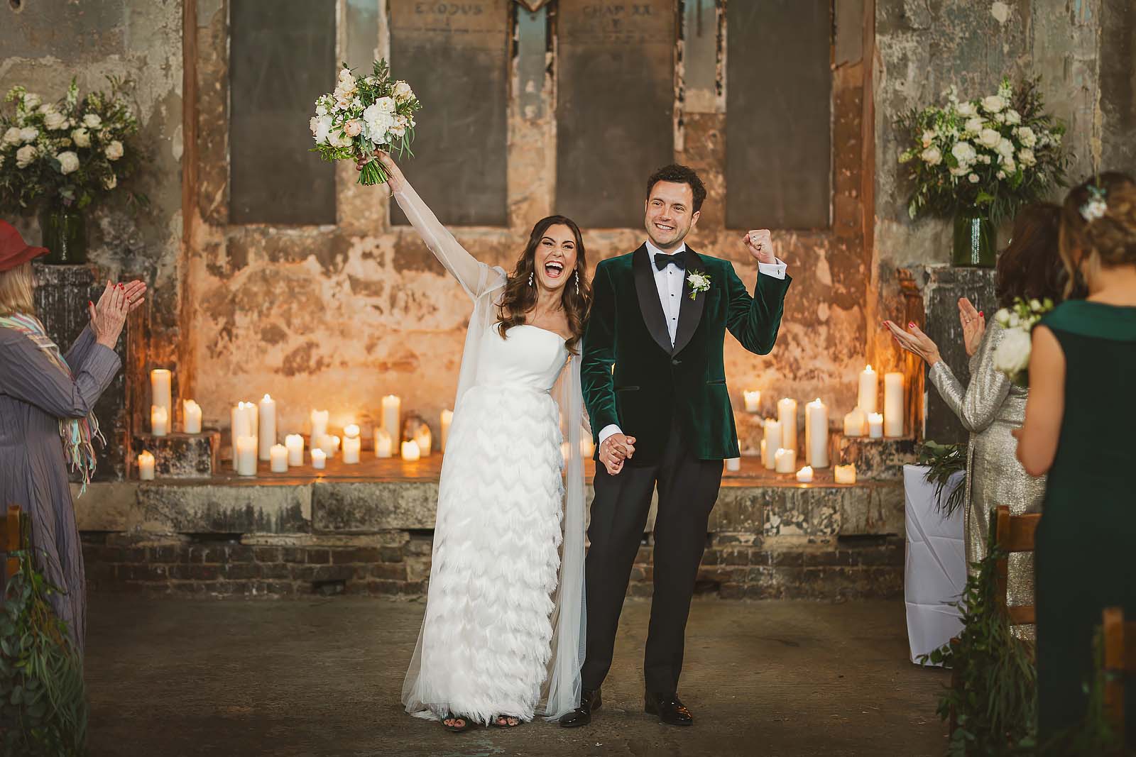 Couple celebrating at the end of their wedding ceremony at Asylum Chapel, London