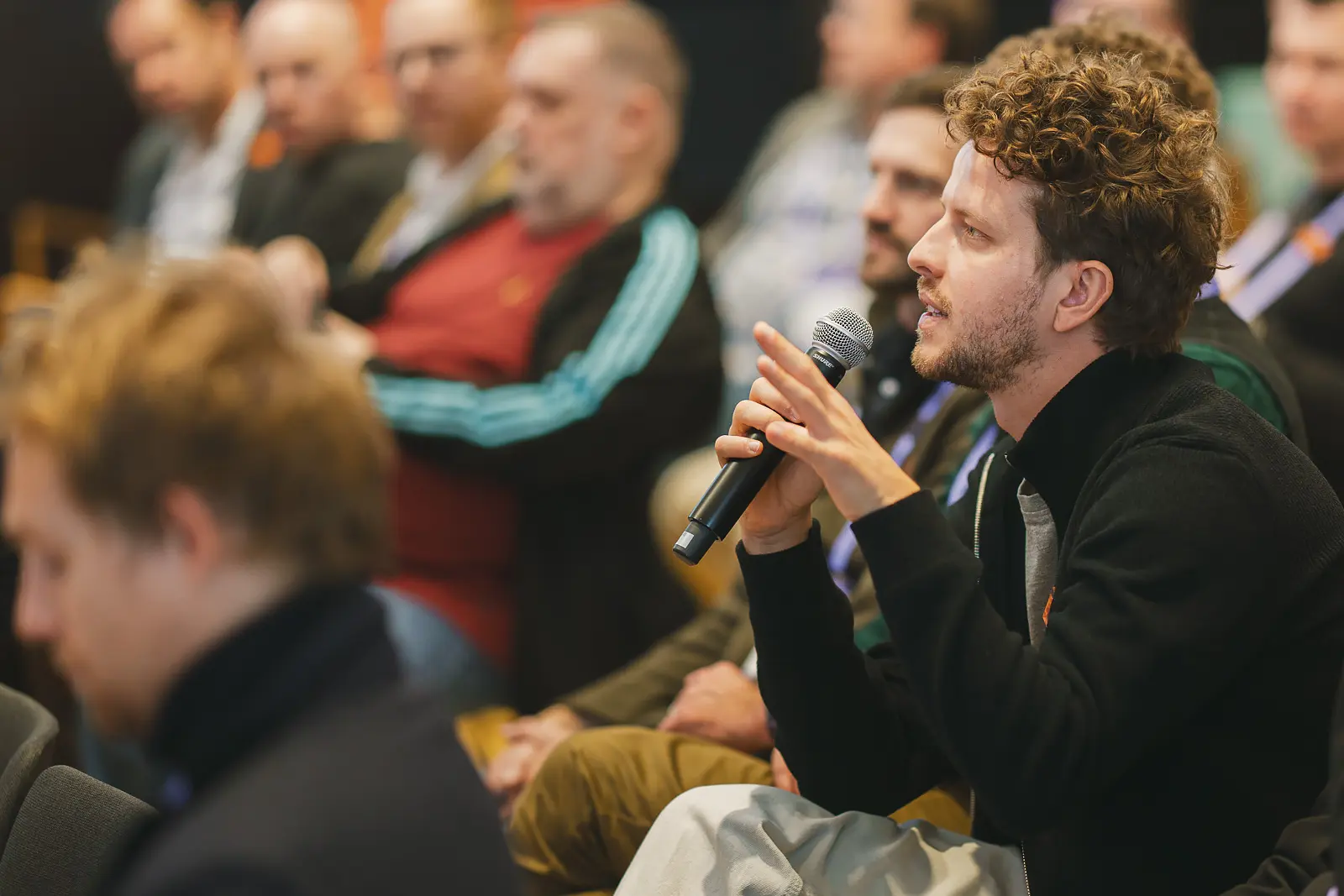 Conference delegate asking a question during a talk at the Science Museum in London