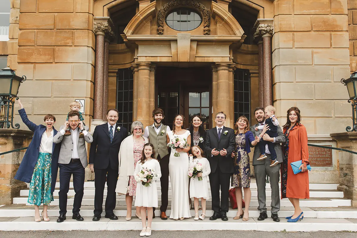 Bride and groom with family and guests outside Bournemouth Town Hall register office after their wedding ceremony