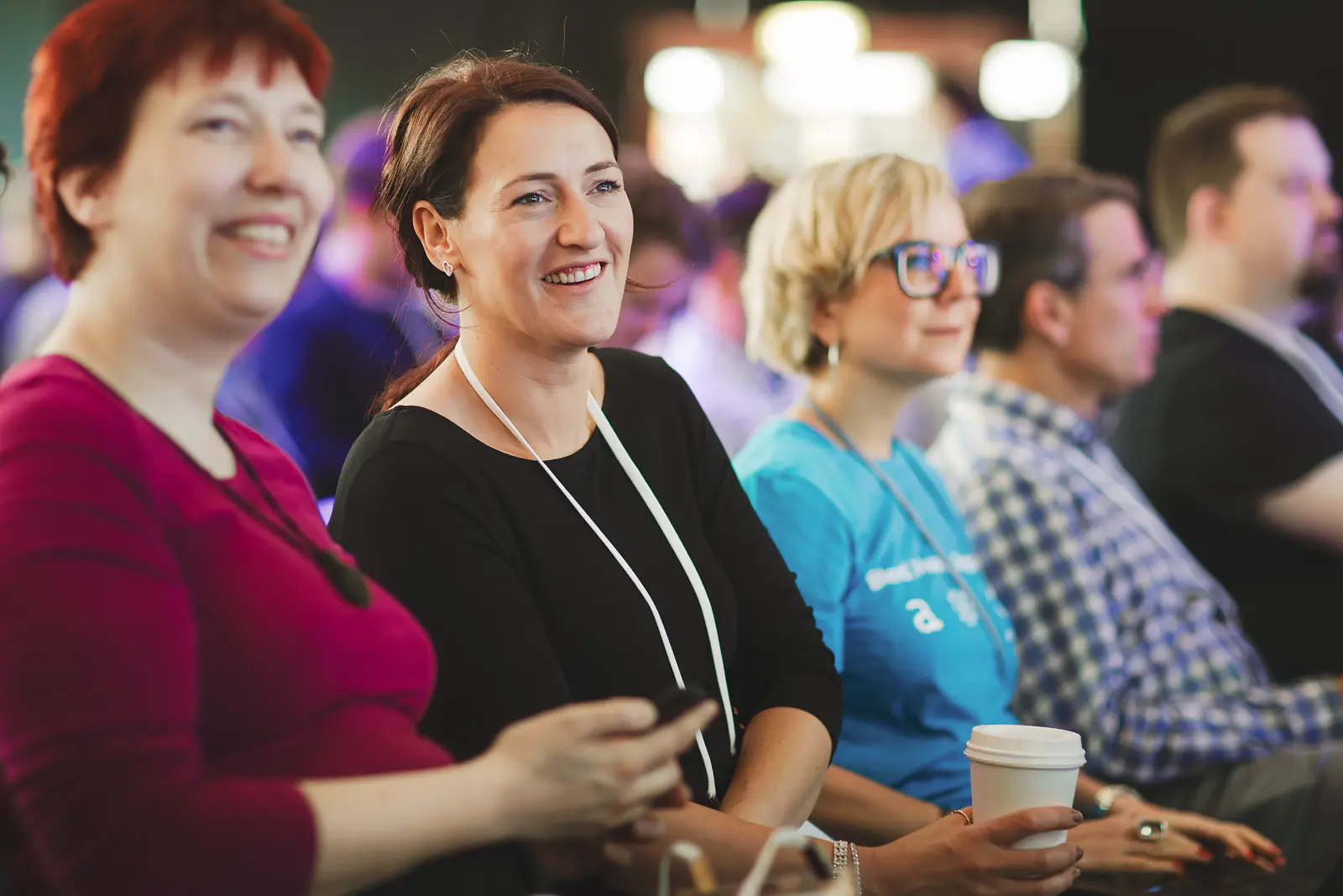 Conference delegates reacting during a talk at a business event in London