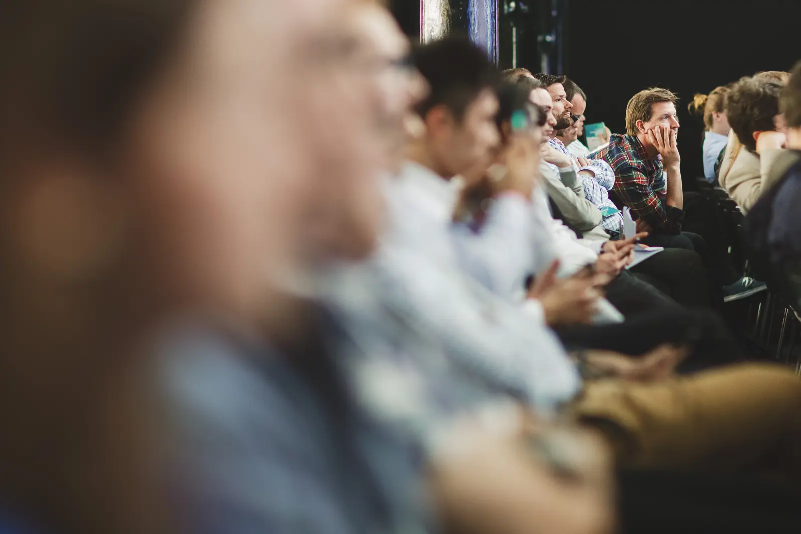 Conference audience listening during a talk at Tobacco Dock in London