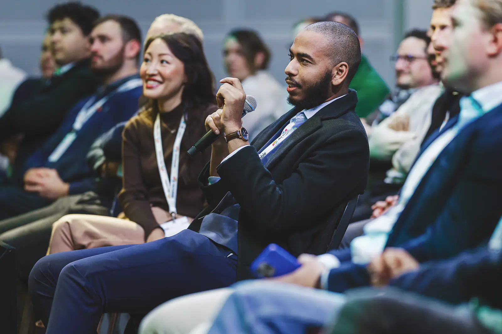 Conference delegate asking a question during an audience Q&A session