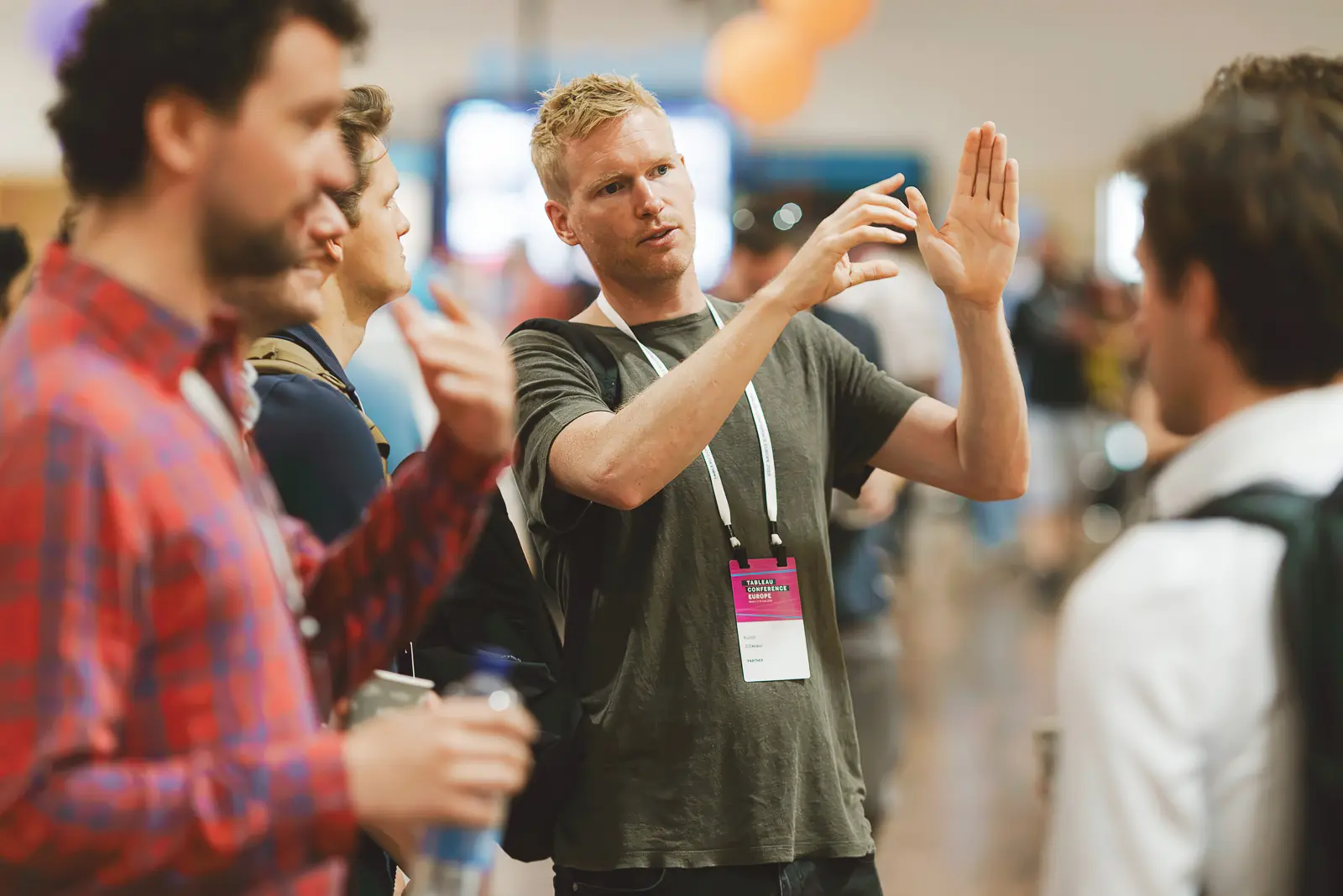 Conference delegates in conversation during a networking break at a business event