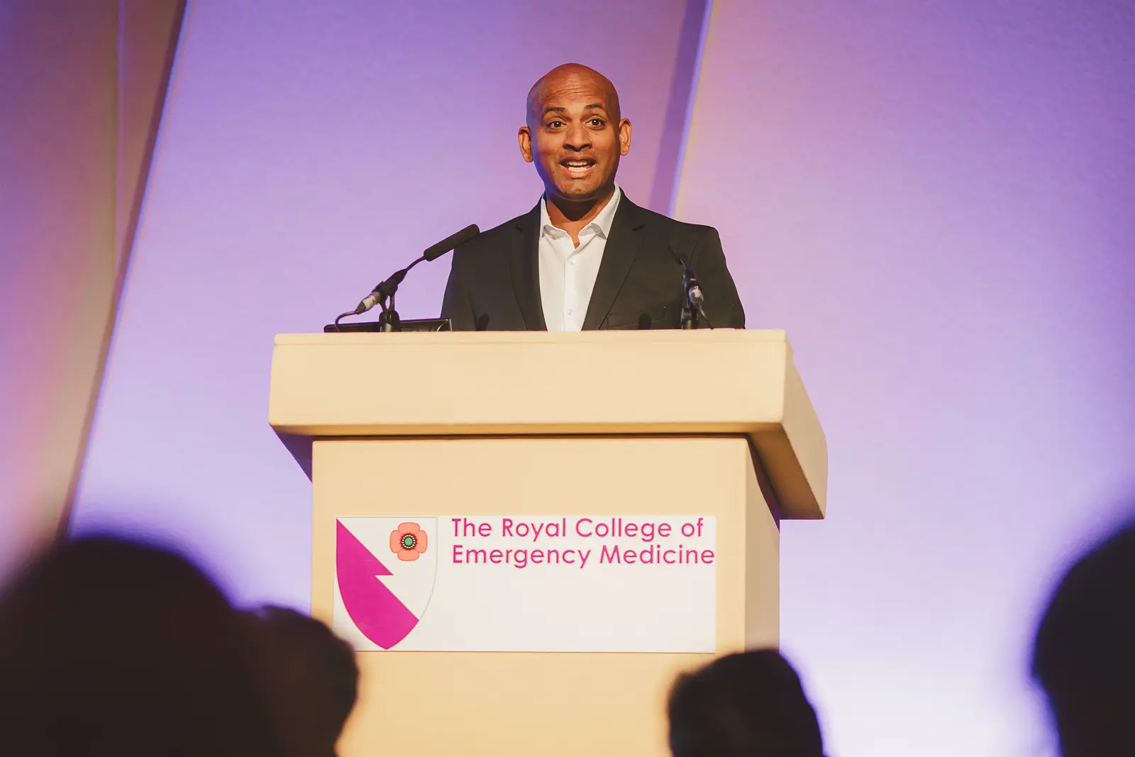 Conference speaker presenting on stage at Bournemouth International Centre