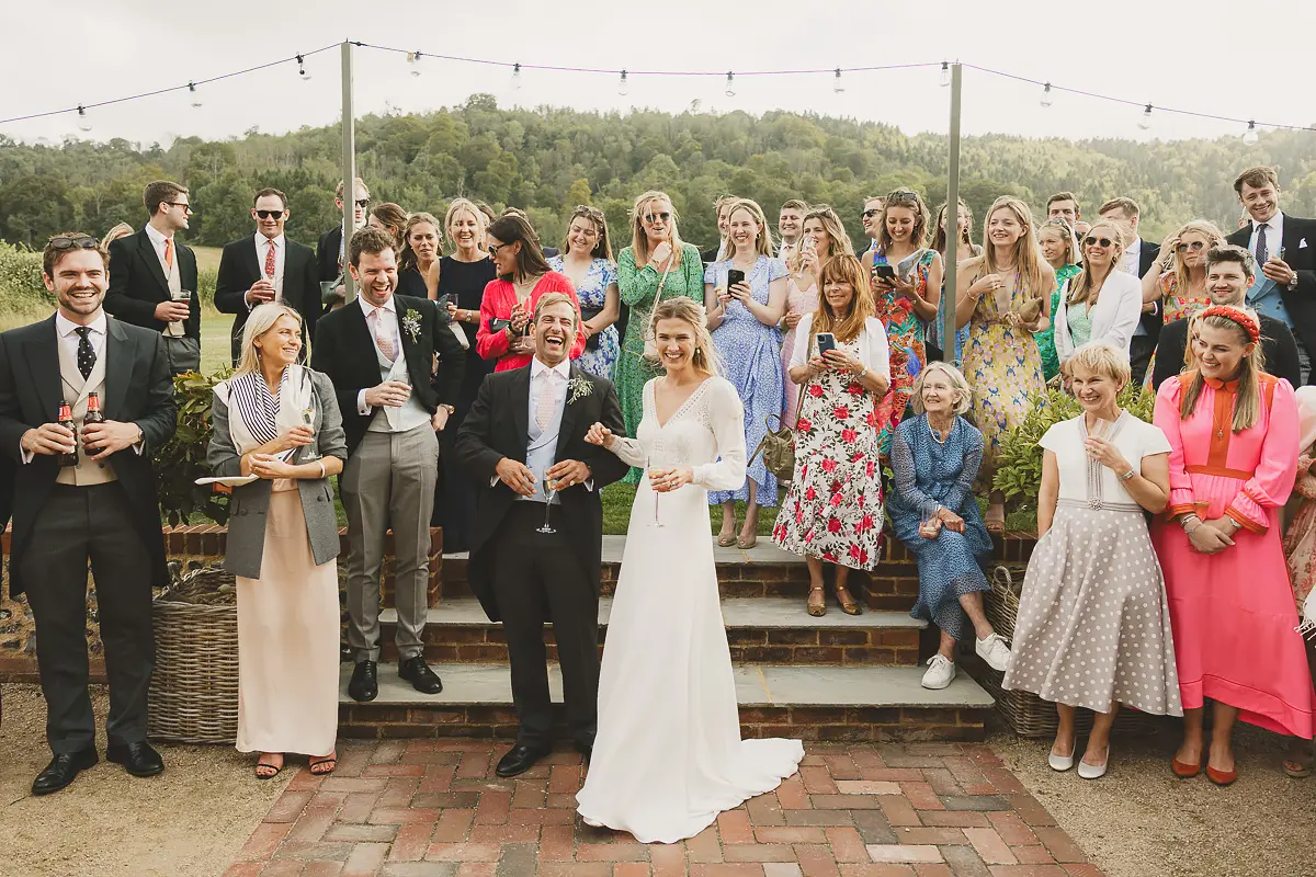Couple laughing with guests during drinks reception at a Dorset wedding venue