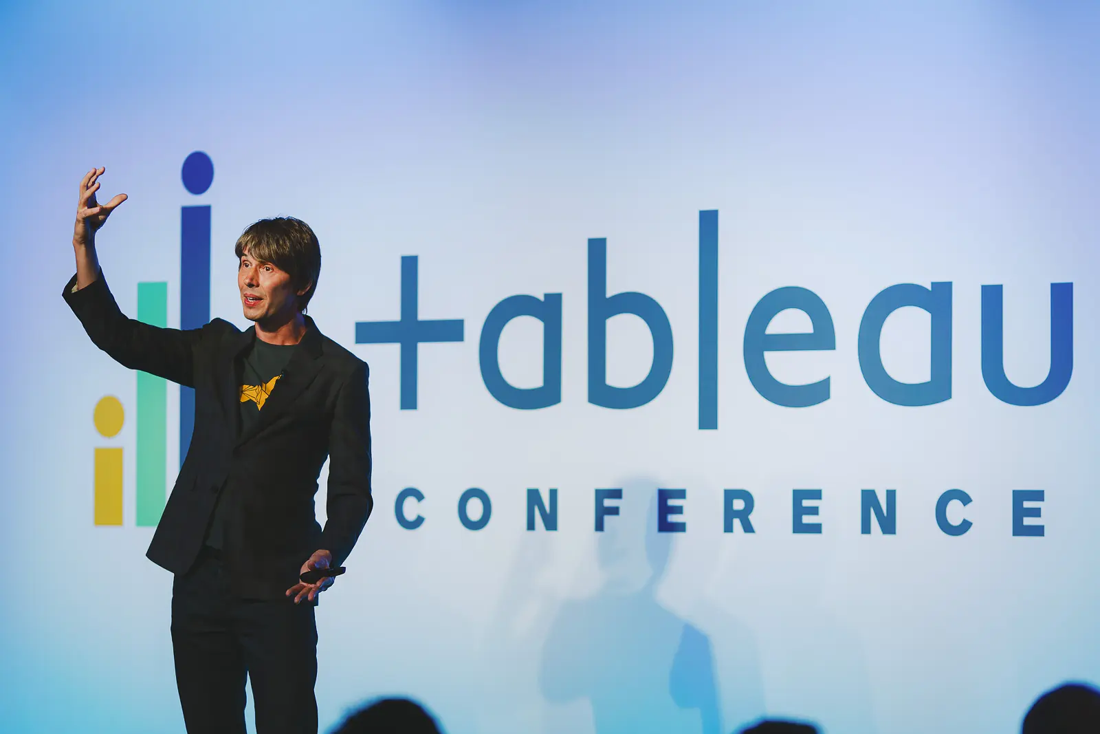 Keynote speaker presenting on stage during a conference in London Tobacco Dock