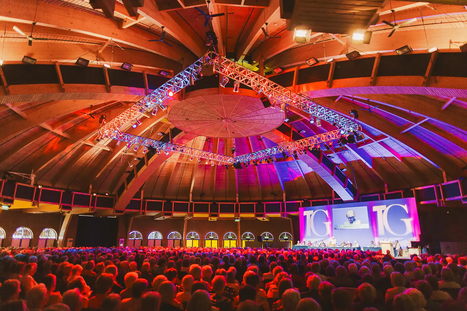 Large conference audience gathered inside Bournemouth International Centre during a keynote presentation