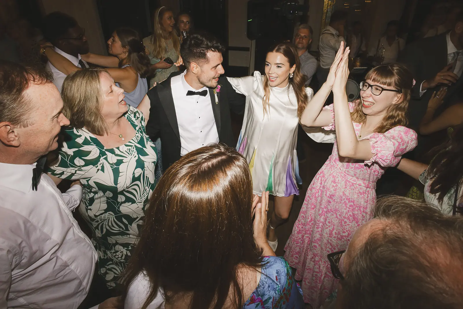 Bride and groom dancing with guests at Larmer Tree Gardens wedding reception