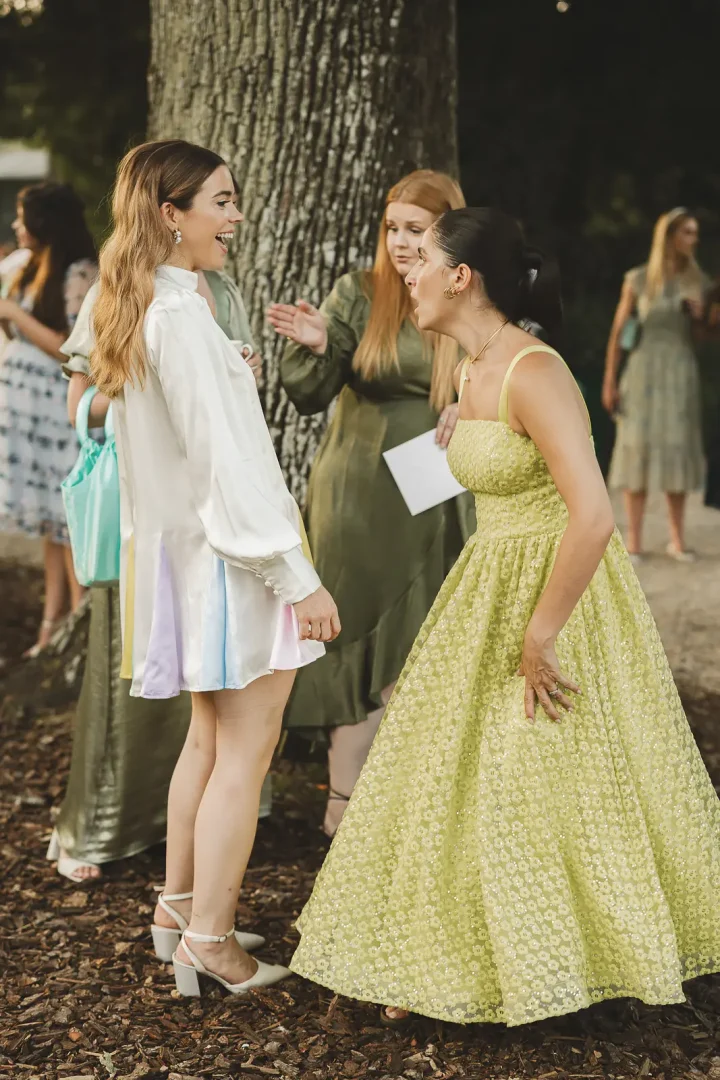 Guests reacting as bride reveals Oliver Rubin Dora reception dress at Larmer Tree Gardens wedding