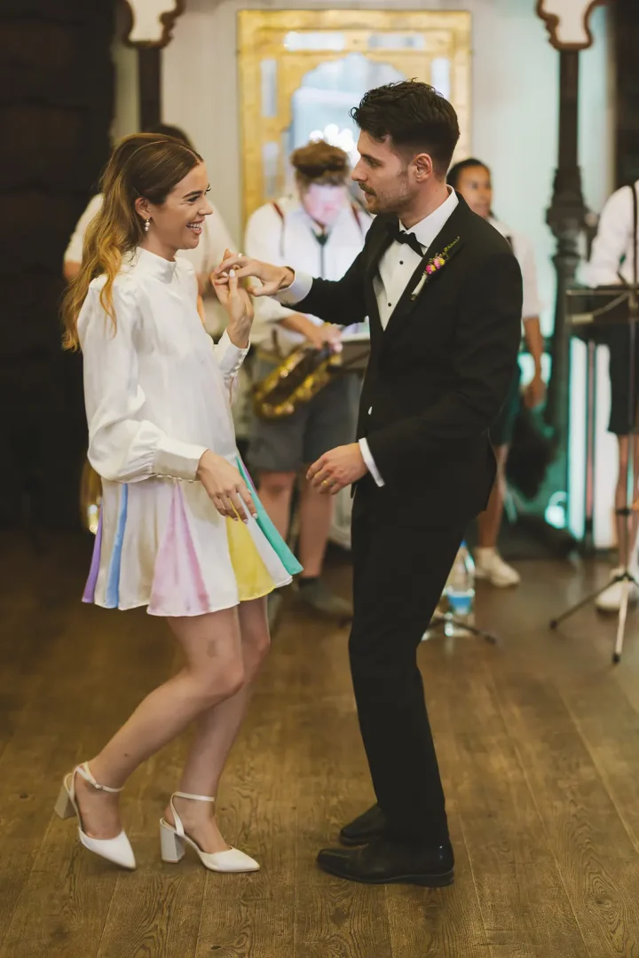 Bride and groom dancing together during evening reception at Larmer Tree Gardens