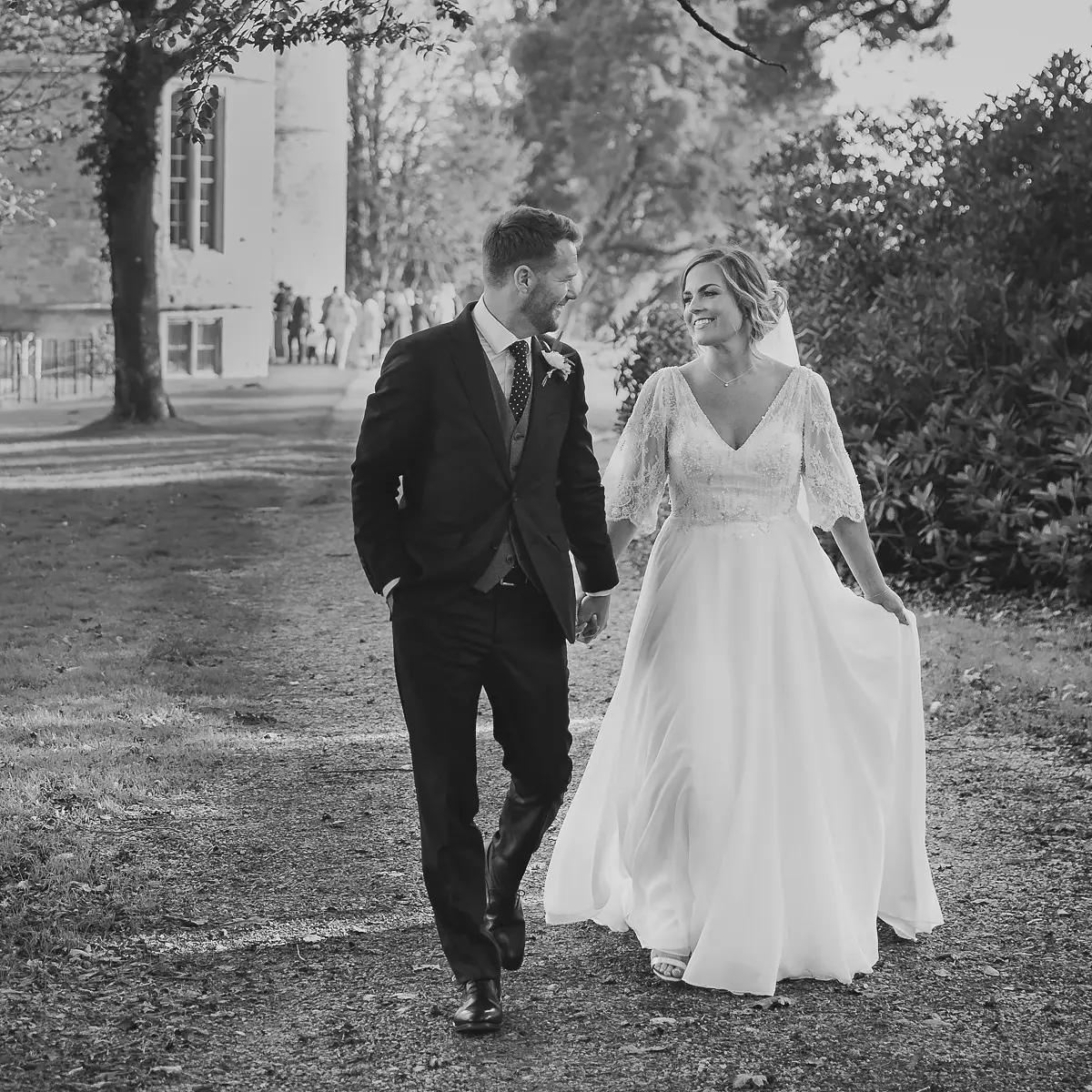 Bride and groom walking through the grounds at Lulworth Castle, Dorset