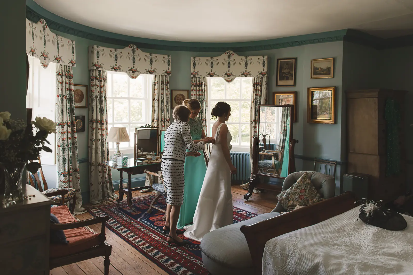 Bride getting ready in a bedroom at Smedmore House Dorset during wedding morning preparations