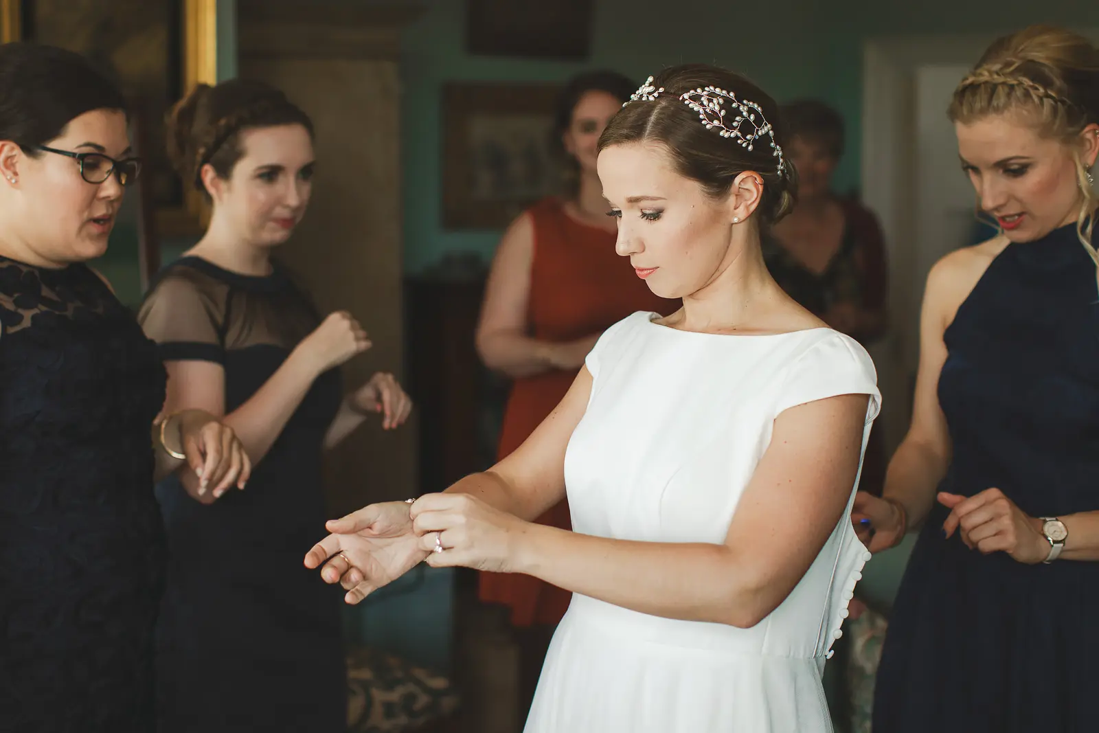 Bride getting ready with bridesmaids during morning preparations inside Smedmore House in Dorset
