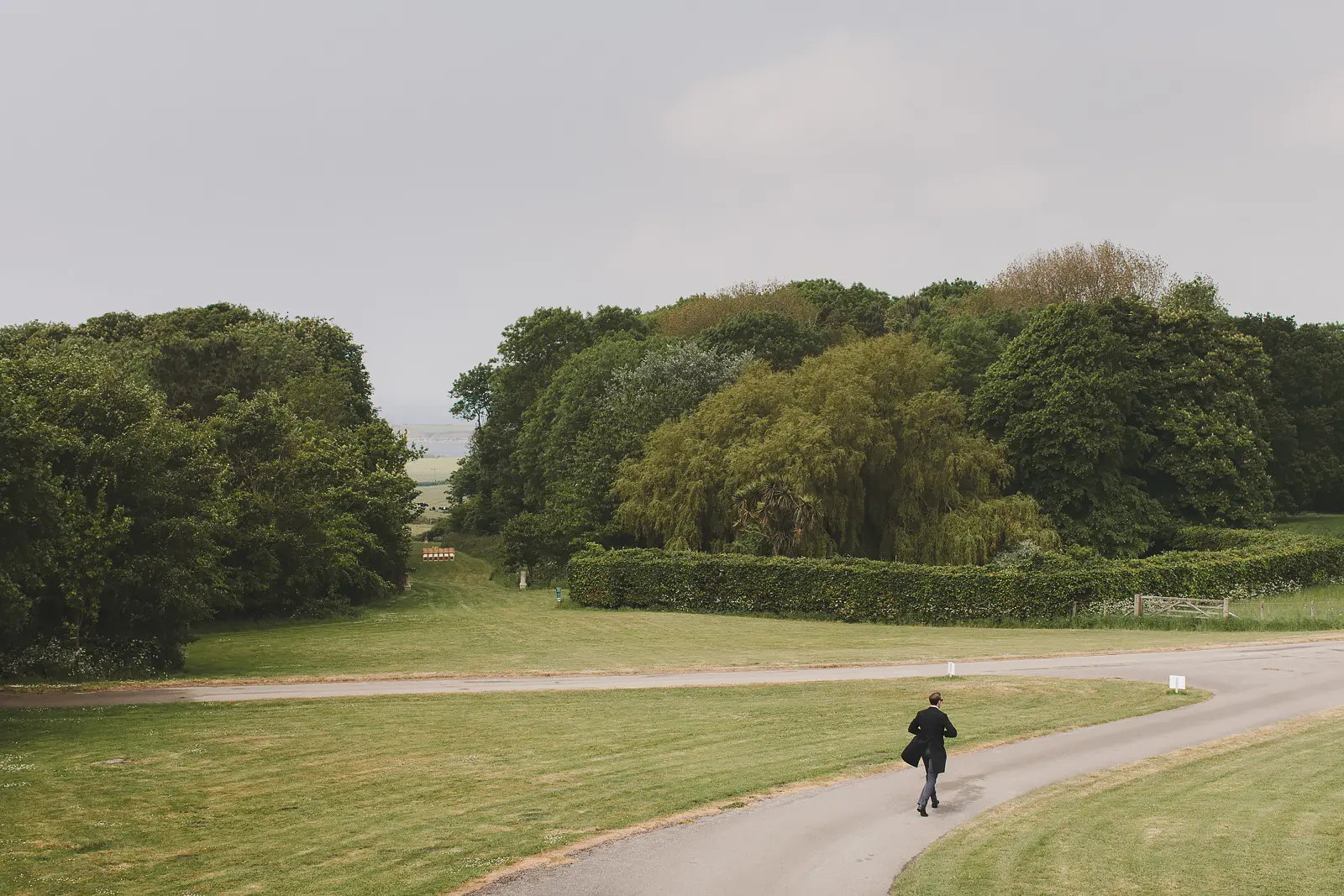 Guest walking along the driveway at Smedmore House with views towards the Dorset coast