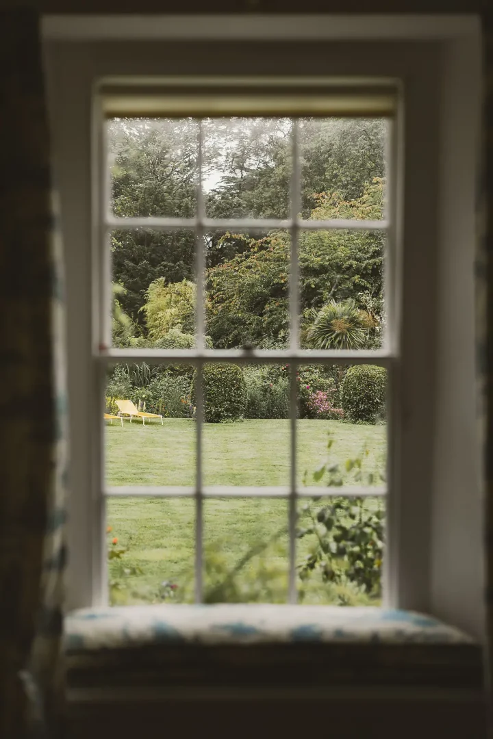 View from inside Smedmore House looking out through a window onto the garden in Dorset