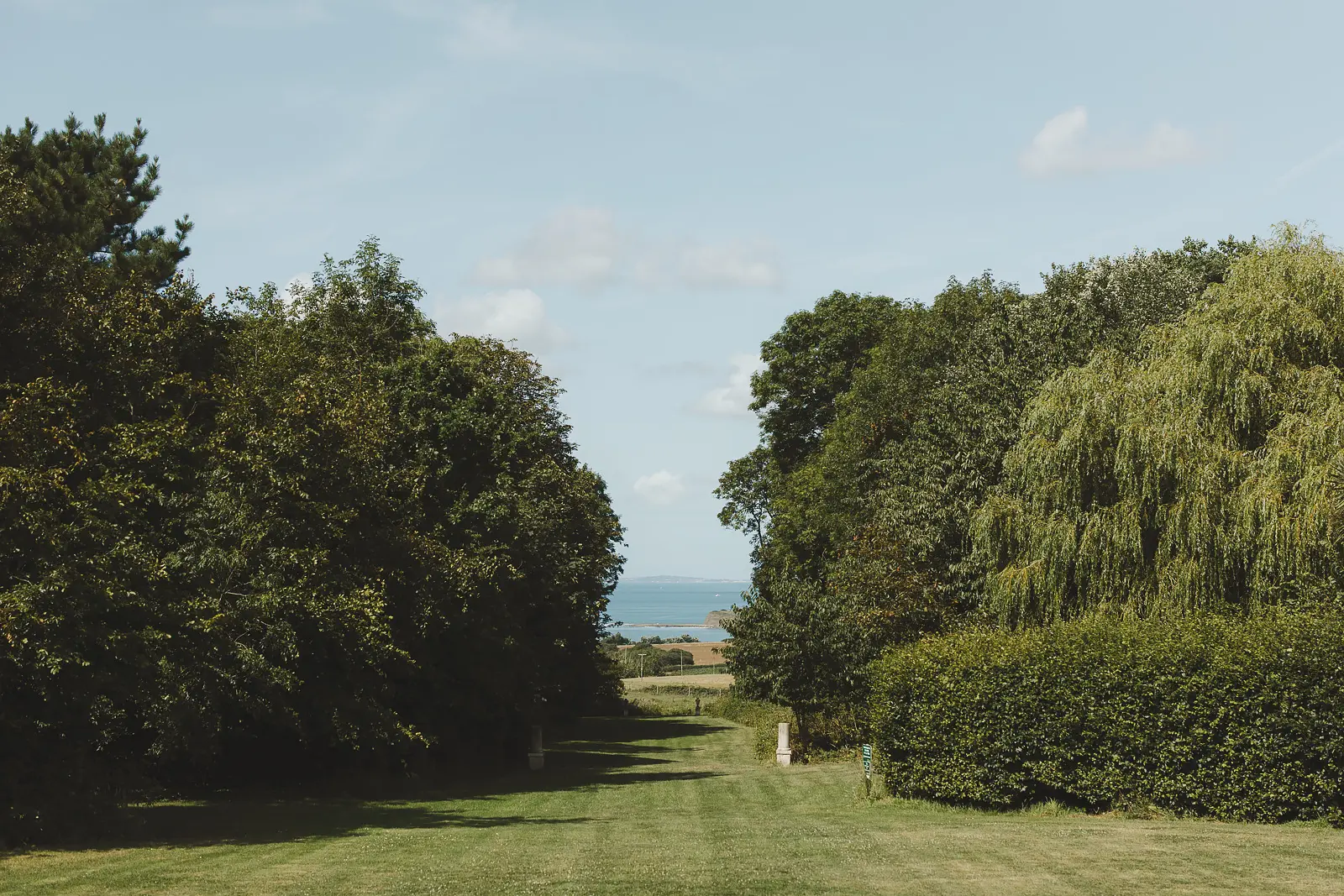View down the tree lined lane at Smedmore House towards Kimmeridge Bay Dorset