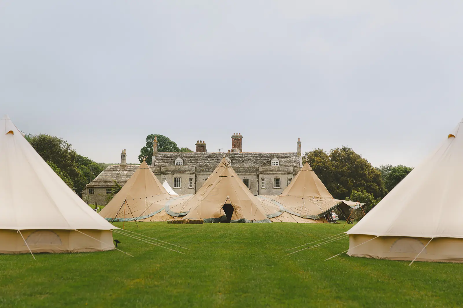 Tipi wedding marquee set on the lawn in front of Smedmore House in Dorset