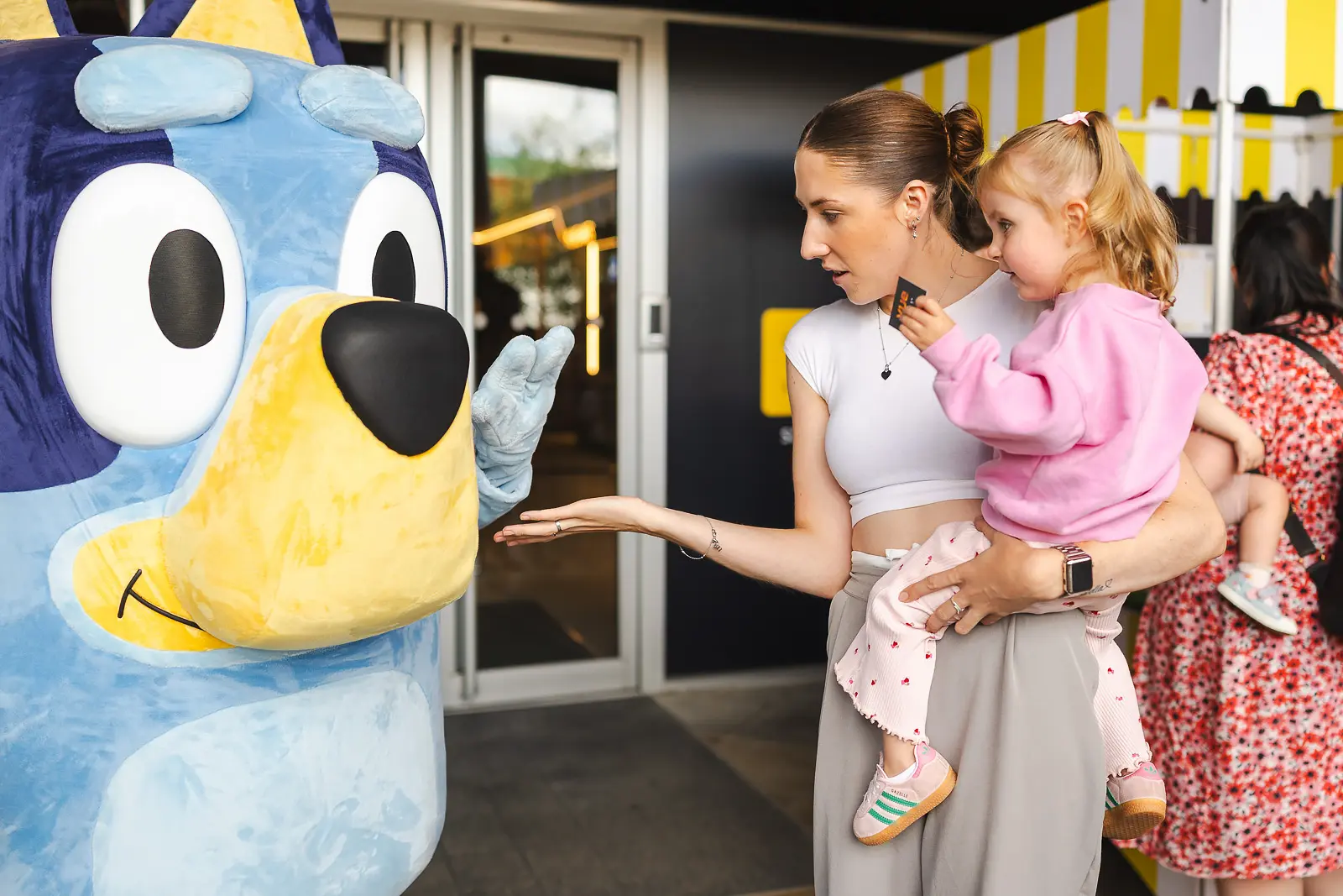Child meeting the Bluey character at a family event at Vue Cinema in Poole