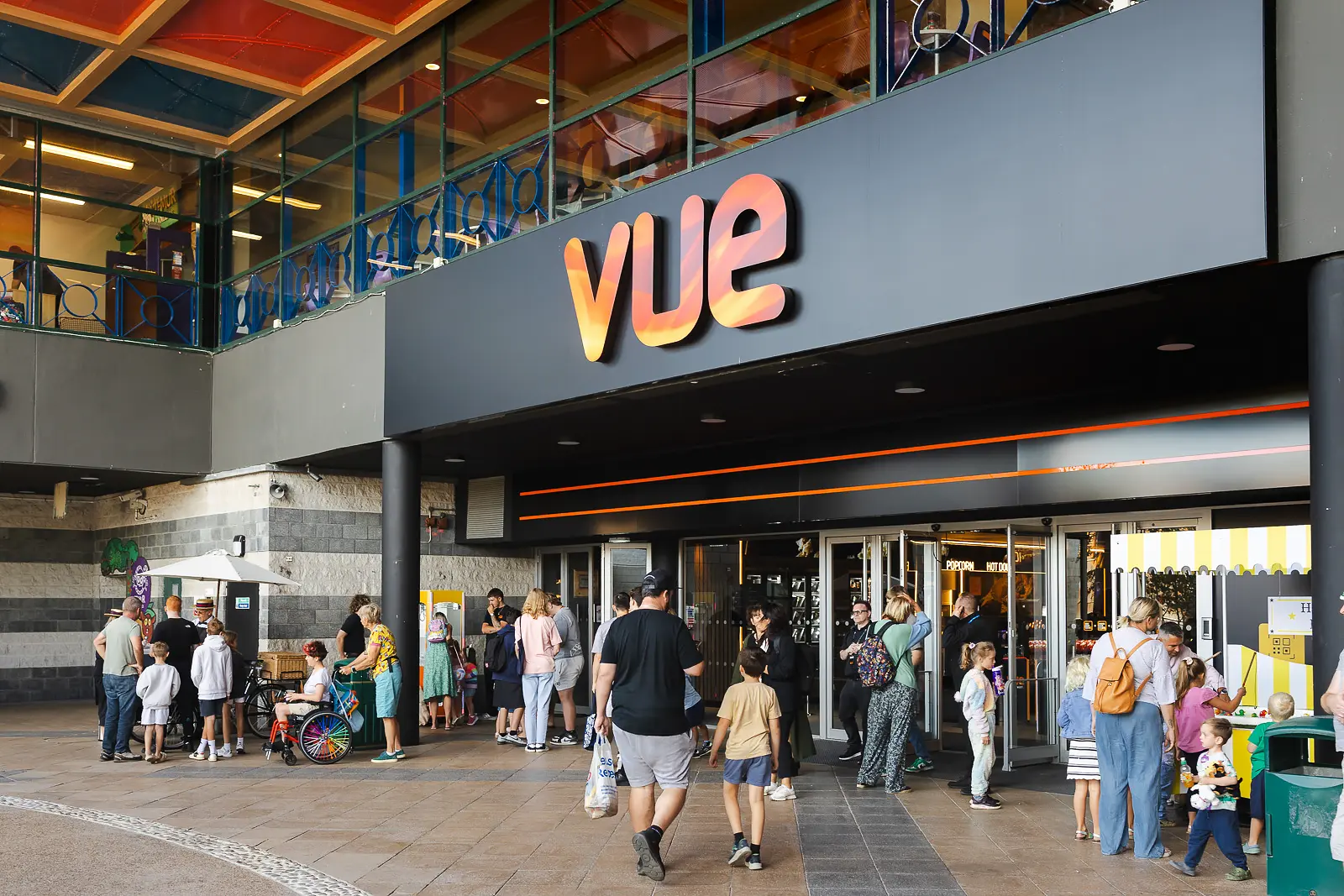 Families arriving at an outdoor brand activation event at Tower Retail Park in Poole on a summer morning