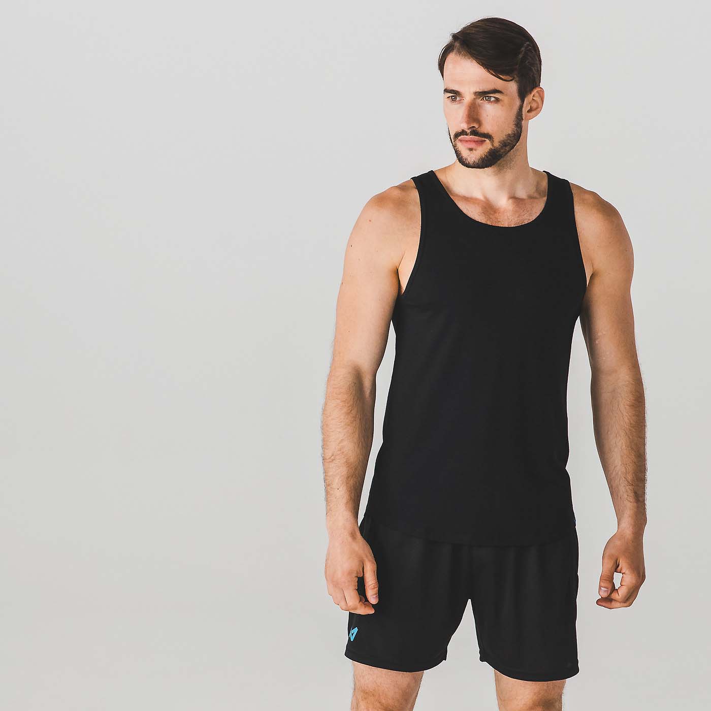 Male model in black vest and shorts, studio fashion photography for a Dorset athleisure brand
