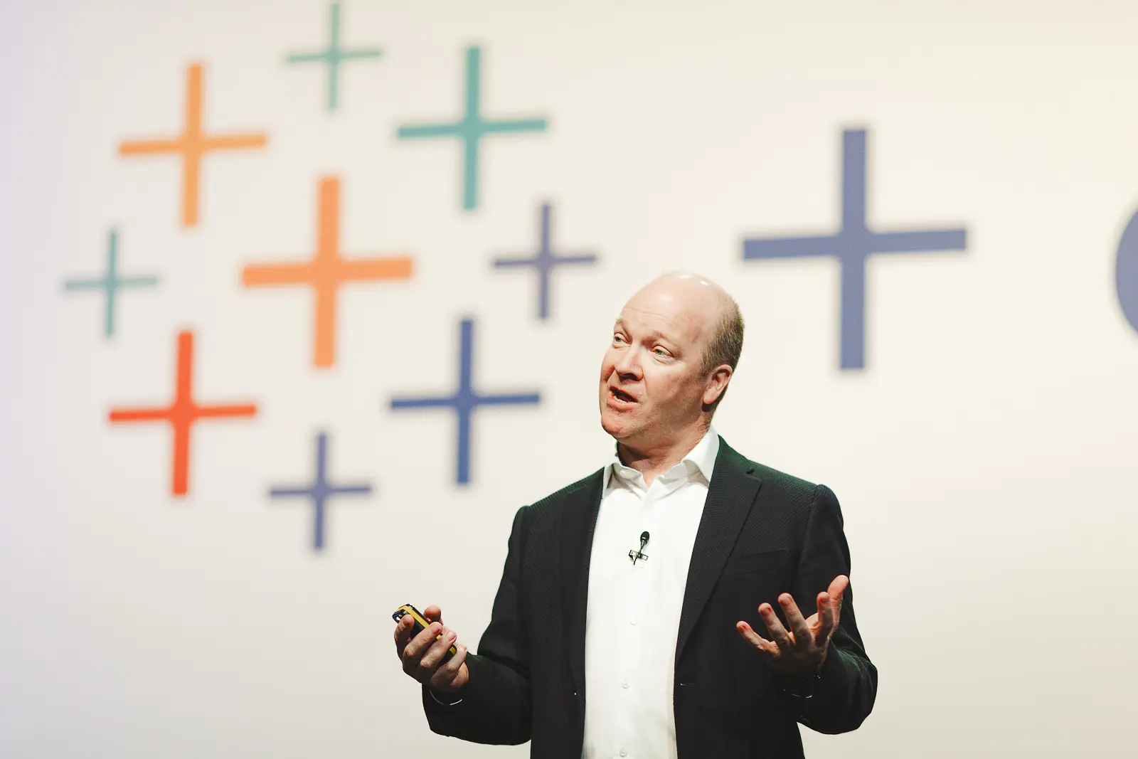 Keynote speaker presenting on stage at an ExCeL London conference