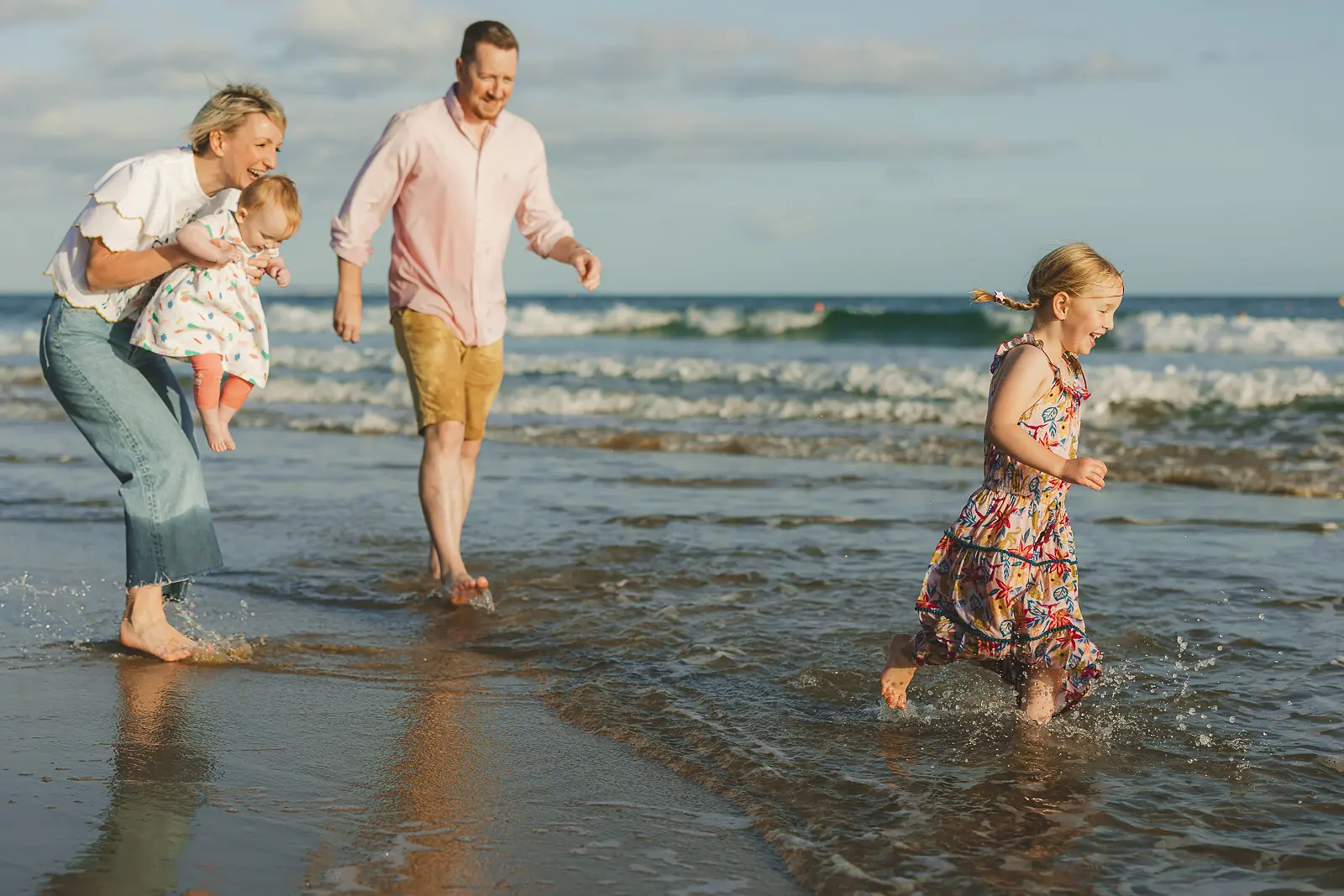 Relaxed family photography on the beach in Poole, with children playing by the sea