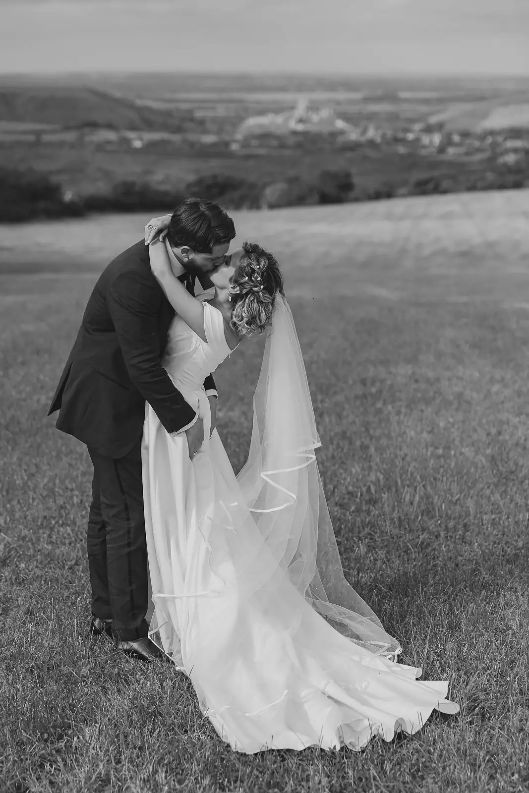Black and white wedding portrait of a couple on a Dorset hilltop, wedding photography by Paul Underhill