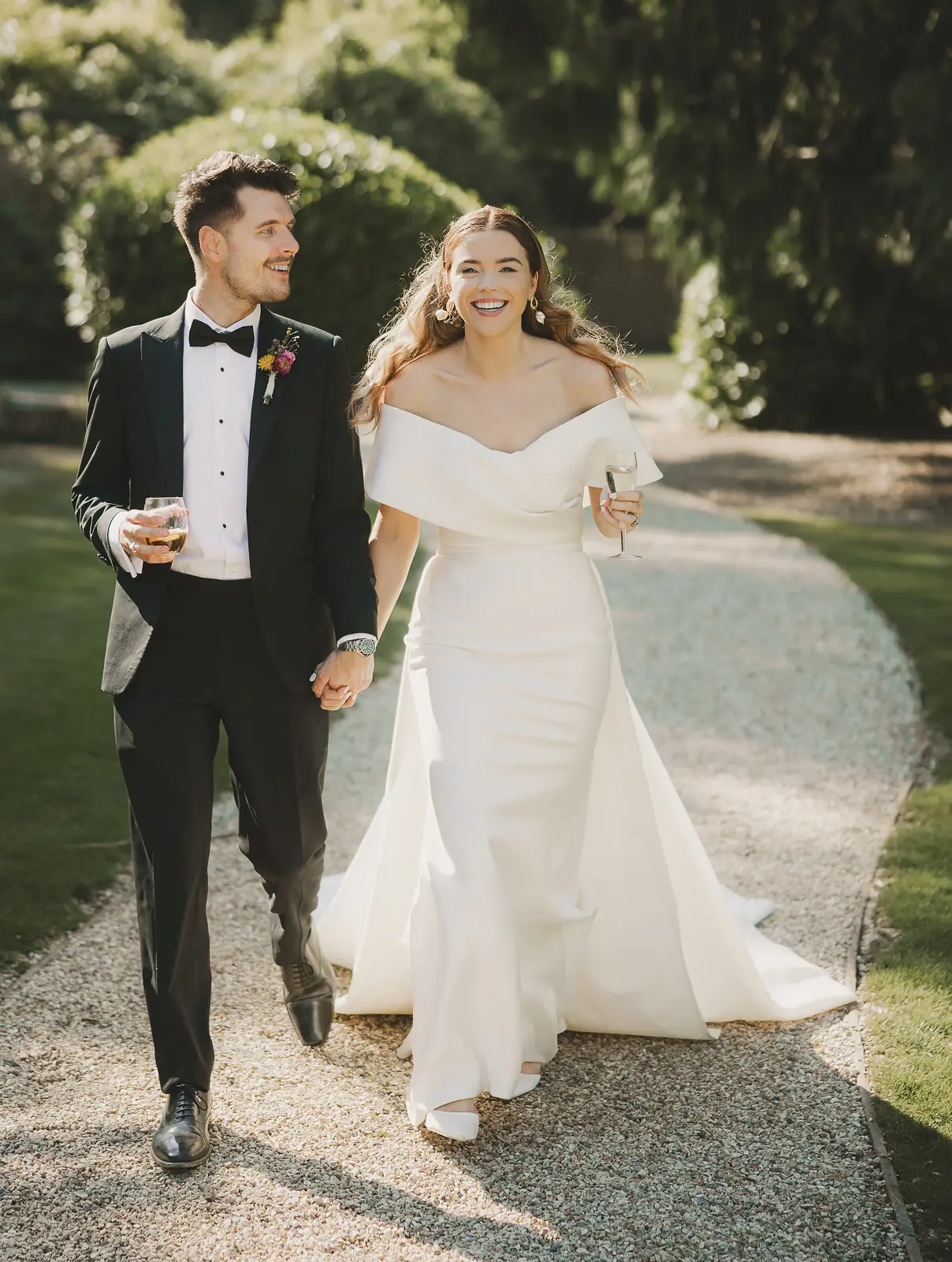 Couple walking through Larmer Tree Gardens on their wedding day, photographed by Paul Underhill