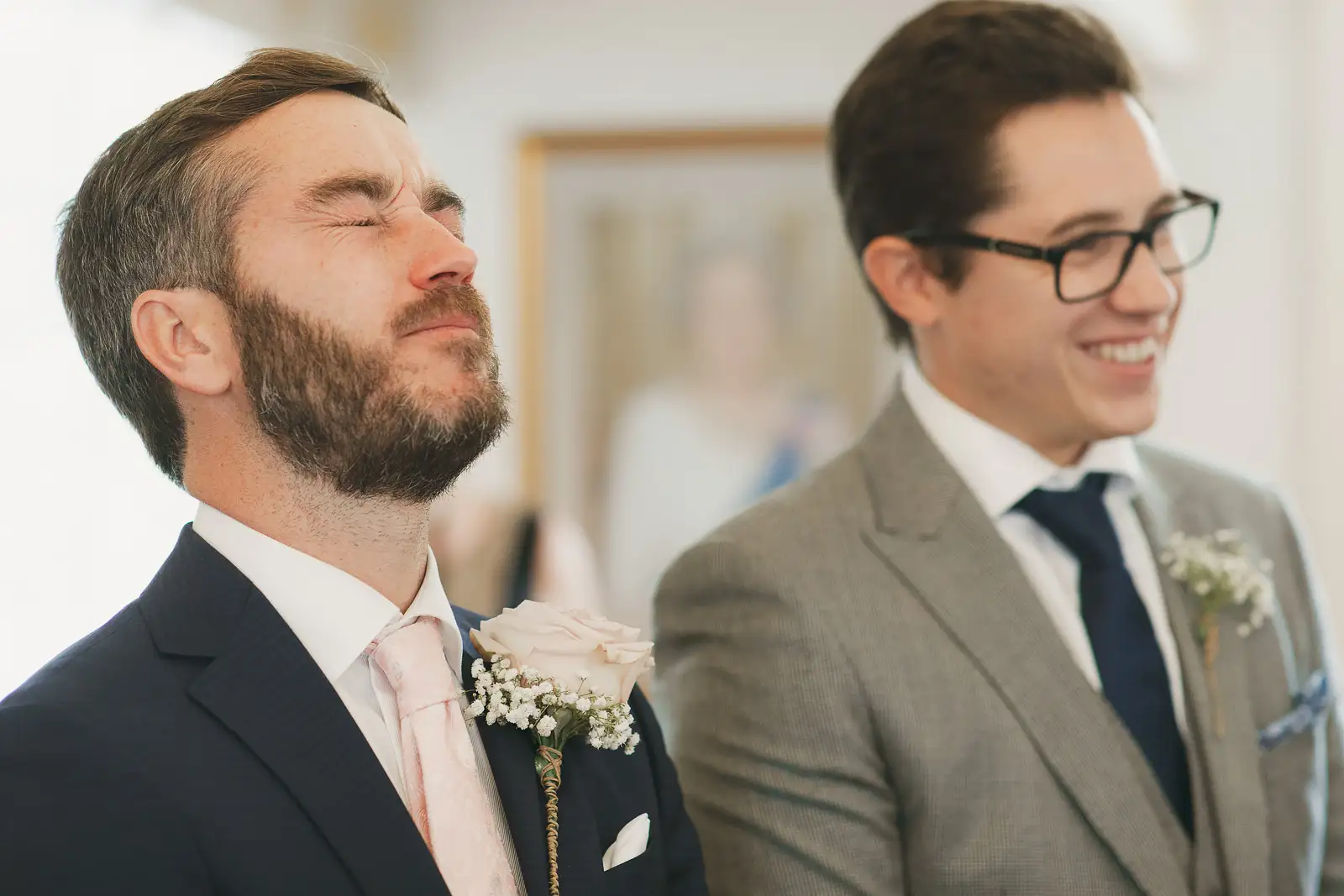 Emotional groom overcome with tears during wedding ceremony at Poole Guildhall, best man smiling beside him